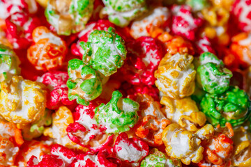 Popcorn in multicolored sweet glaze, in bulk, close-up, selective focus