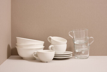 Fototapeta na wymiar Clean dishes on the table. Preparing for lunch or dinner. Modern dinnerware.