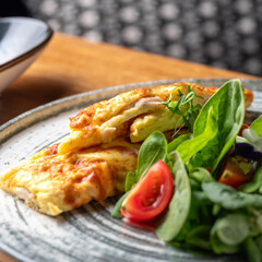 Classic omlet with chiken fillet and mozzarella serving in a restaurant, menu food concept. - obrazy, fototapety, plakaty