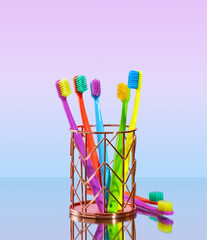 A large number of brightly colored toothbrushes in holder. Teethcare concept.