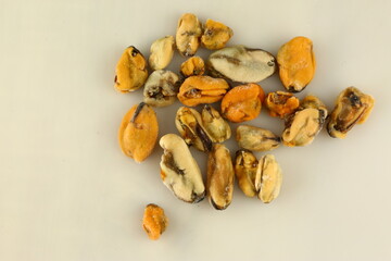 frosted mussels without shell closeup photo on white table background