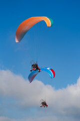 Flying with paramotor in the blue sky - Man riding paramotor in the blue sky background