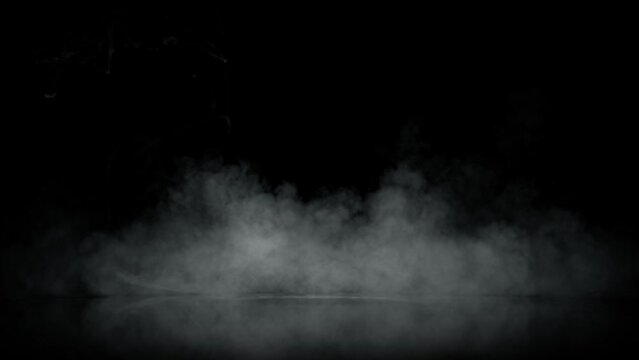 Super Slow Motion Shot of Atmospheric Smoke Slowly Floating on Black Background at 1000fps.