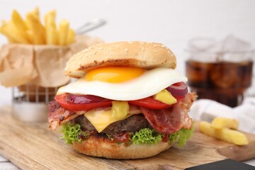 Delicious burger with fried egg on table, closeup