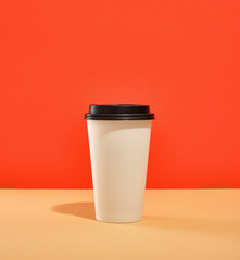 Cup of coffee or tea with black cover. Drinking coffee or tea in the morning. Takeaway coffee.