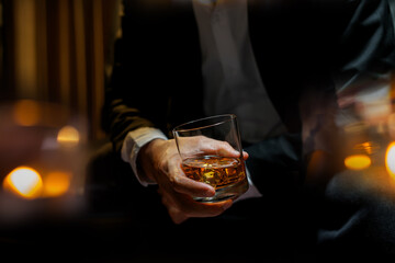 businessmen holding a glass of whiskey - Powered by Adobe