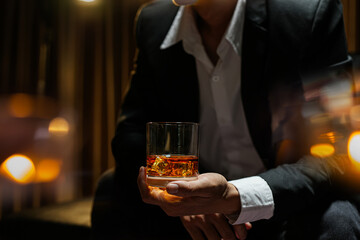 businessmen holding a glass of whiskey