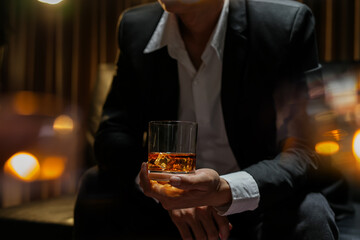 businessmen holding a glass of whiskey