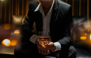 businessmen holding a glass of whiskey