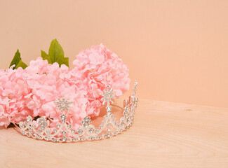 Diamond expensive tiara and spring gorgeous flowers. Copy space for text.