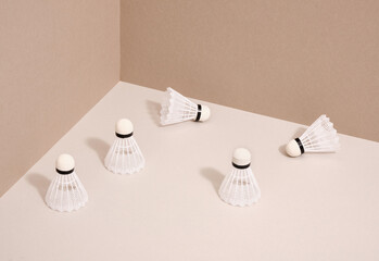 A few white badminton shuttlecocks lie on the table. Sport accessories to play games.