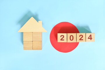 Year 2024 house or home ownership and real estate property investment concept. Wooden blocks on...