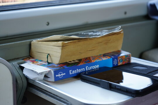 books on a table in the train, road trip through eastern europe interrail