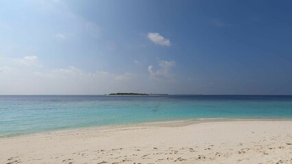 Fototapeta na wymiar Maldives beach, waves wash the shore with white sand, clear azure water, and blue sky. Beauty, paradise, Indian ocean view