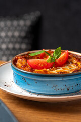 Traditional Italian lasagna with tomato and meat sauce baked with cheese. Fragment with a blurred background.