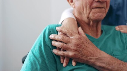 Holding hands, senior and woman with wheelchair with empathy and support check for cancer in a retirement home. Sorry, love and care with hope with hospital and kindness with sick patient at clinic - Powered by Adobe