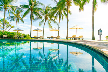 Beautiful umbrella and chair around swimming pool in hotel and resort