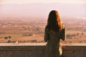 Happy woman admiring the beautiful view in the city of Perugia, Italy.
