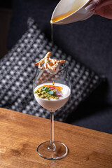 Delicious double colored mango panna cotta mousse pudding with diced mango pulp flesh topping on...