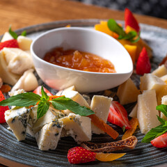 Cheese plate served with nuts and honey