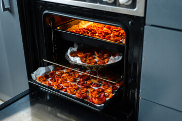 Cooking sun-dried tomatoes in the oven in the kitchen