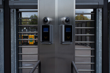 Metal structure for stadium access with ticket scanner and video surveillance camera.