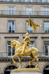 golden statue of Joan of arc on horseback in Paris, sculpted by Emmanuel Fremiet in 1864.
