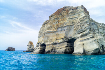 Caves and rock formations by the sea at Sarakiniko area in Milos island, Greece - 672690219