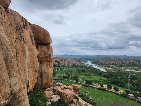 Hampi, Karnataka India - July 24 2023: Kishkinda, Anjanadri Hill, Anjaneya Parvat, the birthplace of Hanuman God now a white temple on top of beige boulder hill.