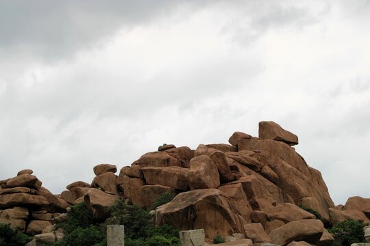 Hampi, Karnataka India - July 24 2023: Kishkinda, Anjanadri Hill, Anjaneya Parvat, the birthplace of Hanuman God now a white temple on top of beige boulder hill.