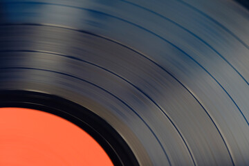 Sound tracks on a vinyl black record closeup macro photo.