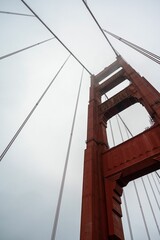 Low-angle shot of the Golden Gate Bridge shrouded in mist. San Francisco, California, USA.