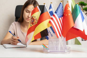 Teenager studying foreign languages, student in a language course with country flags