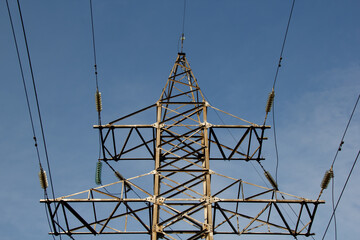 high voltage power lines against the background of blue sky. selective focus .