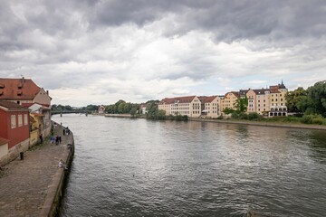 Fototapeta premium Danube River and residential building on Oberer Wöhrd island as viewed from the Old Stone Bridge (German: Steinerne Brücke), Regensburg