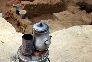 oriental teapot with tea on the background of the excavations of the old town.selective focus . High quality photo