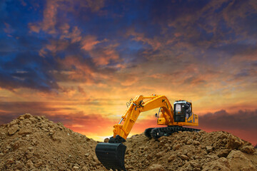 Crawler excavator with bucket  are digging the soil in the construction site on the sunset ...