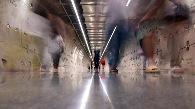 Bangkok, Thailand-Aug, 06 2023: Time lapse of busy people walking in walkway subway underground public transport tunnel of Samyan.