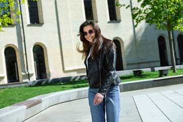 Fototapeta premium cheerful girl with glasses walks outdoors in warm weather