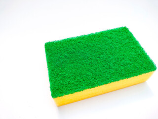 Yellow sponge with green layer for washing the dishes and other domestic needs isolated with white background