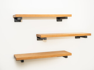 Thick wooden Shelves made by natural oak planks mounted with black japanned steel bracket...