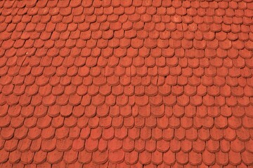Red wooden shingle roof texture.