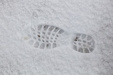 Footstep print in fresh snow in winter.