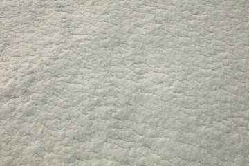 Closeup of snow forming abstract patterns in winter.