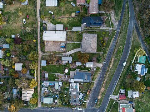Overhead view of houses and properties one yard is full of junk