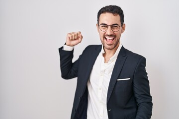 Handsome business hispanic man standing over white background dancing happy and cheerful, smiling moving casual and confident listening to music