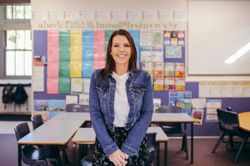 Confident Aboriginal female primary school teacher in her classroom