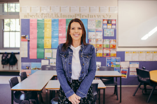 Confident Aboriginal female primary school teacher in her classroom