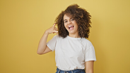 Young beautiful hispanic woman smiling confident doing phone me gesture with hand over isolated...