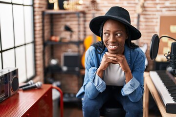 African american woman artist smiling confident wearing hat at music studio